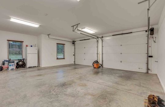 garage, garage doors, concrete flooring, two car garage