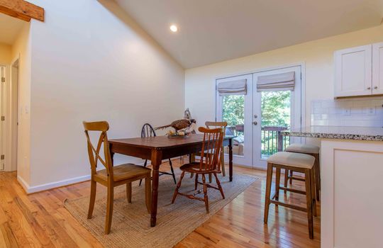 dining area, hardwood flooring, vaulted ceiling, double doors to back deck, recessed lighting