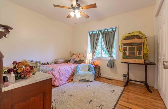 living room, hardwood flooring, ceiling fan, window