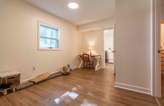 lower level bedroom space, window, vinyl flooring