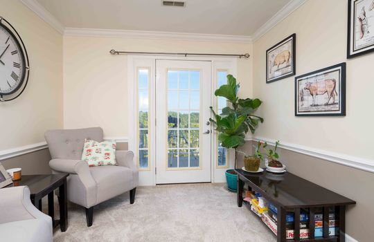 Level 2 sitting area, carpet, exterior door to balcony, wainscoting, crown moulding
