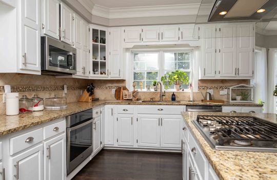 Kitchen, cooktop, oven, microwave, sink, dishwasher, window, cabinets, granite countertops, bay window, hardwood flooring