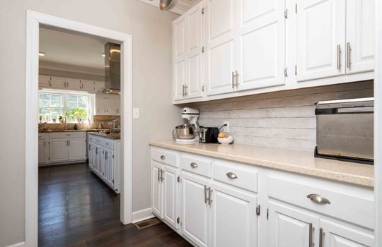 Butler's Pantry, cabinets, countertops, hardwood flooring, doorway to kitchen