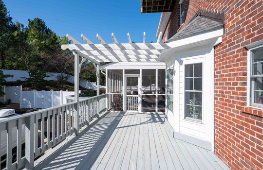 wood back deck, pergola, bay window, screened in porch, back yard view, landscaping, brick exterior