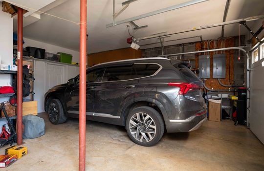 Garage, garage doors, concrete flooring, entry to lower level
