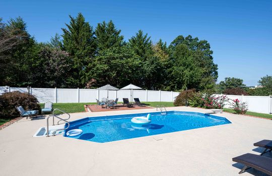 Back yard, In ground pool, brick sitting area, fencing, landscaping,