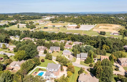 Aerial view of property & neighborhood, mountains, school