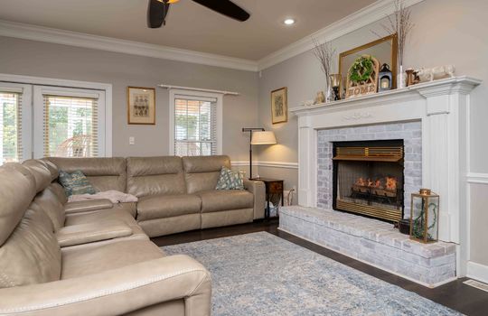 Living room, fireplace, hardwood flooring, crown moulding