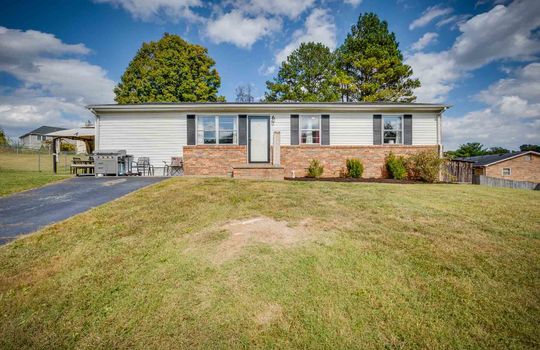 One story home, brick, vinyl siding, front yard, front door, driveway, trees, landscaping