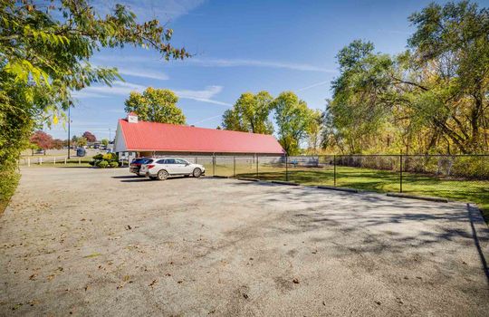 asphalt parking area, parking lot, 13 spaces, red metal room, dog daycare facility, fenced yard/play area
