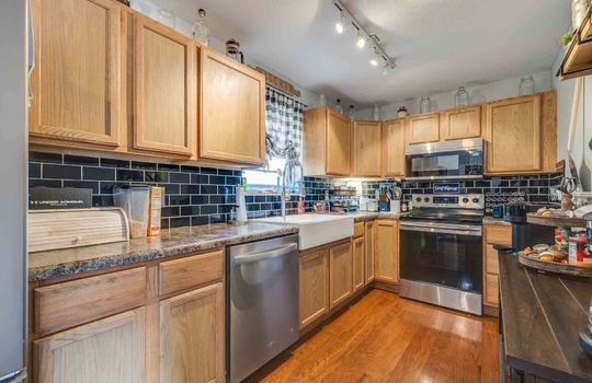 kitchen, refrigerator, stove, dishwasher, sink, cabinets, counters, tile backsplash