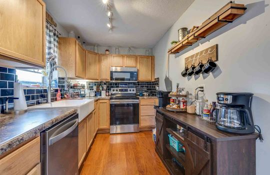 kitchen, stove, dishwasher, sink, cabinets, counters, window, tile backsplash