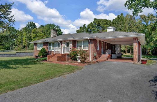 one story brick ranch, carport, driveway, stairs, front yard, front door, trees
