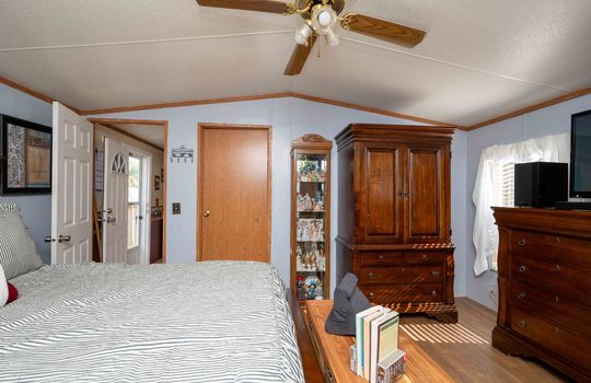 bedroom, ceiling fan, laminate flooring, closet, doorway