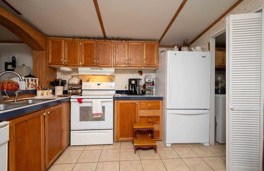 kitchen, cabinets, counters, dishwasher, oven/stove, refrigerator, tile flooring
