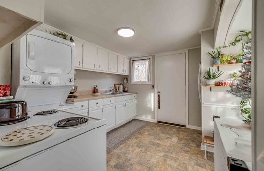 kitchen, exterior door, cabinet, countertops, stove, refrigerator, laminate flooring