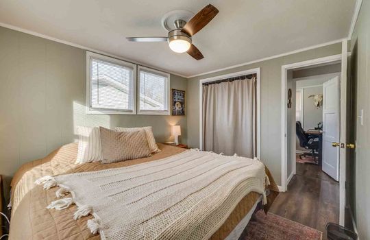 bedroom, closet, ceiling fan, windows, laminate flooring, door to hallway