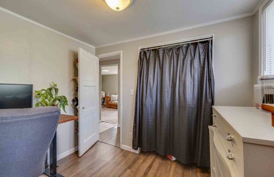 second bedroom, closet, laminate flooring, door to hallway