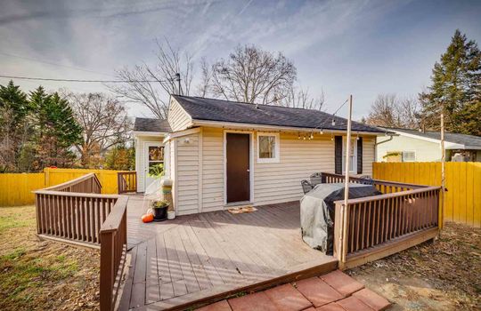 back deck, exterior door, cottage, railing, fenced back yard