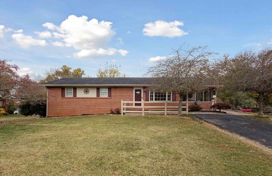 Brick ranch, landscaping, trees, front yard, porch railing, front porch, front door, driveway