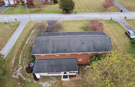 aerial view from back of property, sunroom, road, roof, landscaping