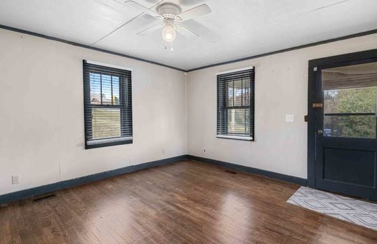 living room, hardwood flooring, windows, ceiling fan