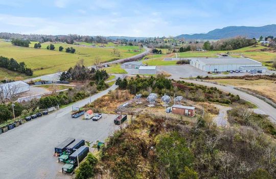 aerial view, commercial property, industrial property, 1.01+/- acres, road frontage, trees, parking lot