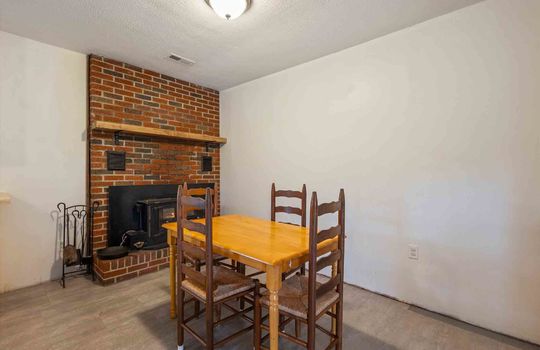 dining area, brick fireplace, luxury vinyl flooring