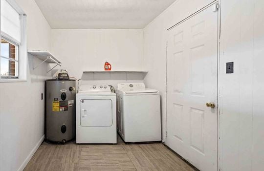 laundry area, luxury vinyl flooring, water heater, washer & dryer hookups, exterior door
