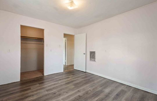bedroom, luxury vinyl flooring, closet, door to hallway