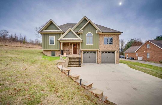 split foyer, brick, hardiplank siding, two car garage, front yard, front steps, front door, concrete driveway, retaining wall, landscaping