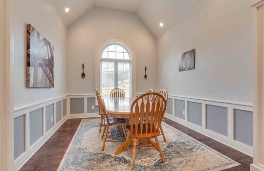 dining area, wainscoting, arched ceiling, recessed lighting, arched window