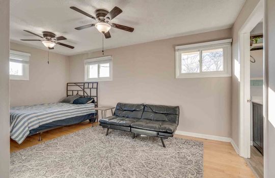 bedroom, hardwood flooring, windows, ceiling fan