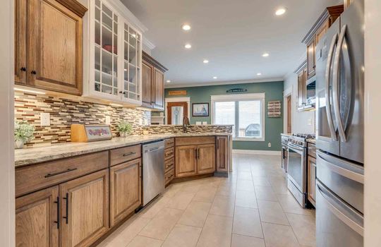 galley kitchen, tile flooring, granite counter tops, stainless steel appliances, range/oven, microwave, dishwasher, refrigerator, sink, cabinets, counters