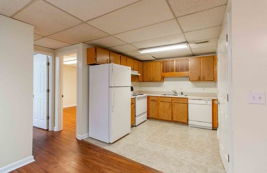 unit 4 kitchen, tile flooring, cabinets, refrigerator, sink, dishwasher, laundry area, drop ceiling