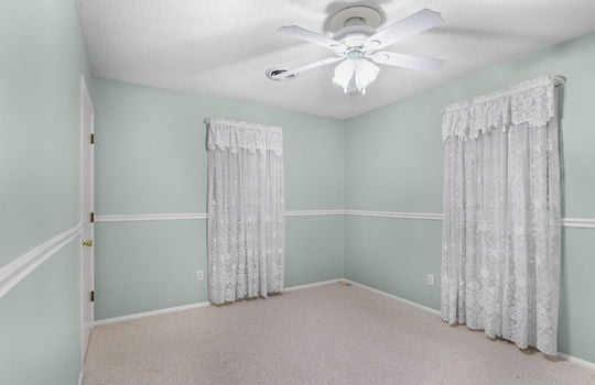 freshly painted bedroom, chair railing, ceiling fan, carpet