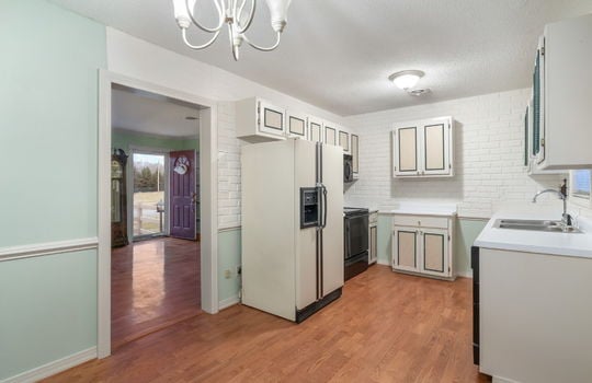 freshly painted dining area/kitchen, refrigerator, stove, cabinets, sink, dishwasher, hardwood flooring