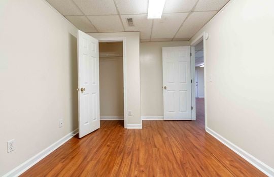 bedroom 1 , unit 4, laminate flooring, closet, drop ceilings