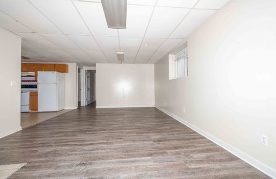 unit 1 living room, laminate flooring, drop ceiling, open kitchen