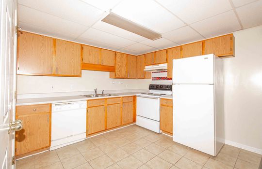 unit 1 kitchen, stove, refrigerator, dishwasher, cabinets, counters, tile flooring