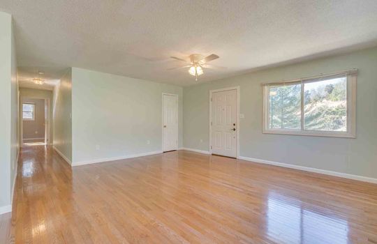 Living room, front door, ceiling fan, hardwood flooring, windows, closet