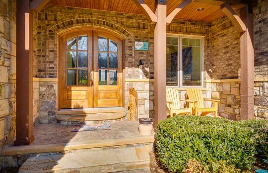arched front door, front porch, stone steps, brick exterior