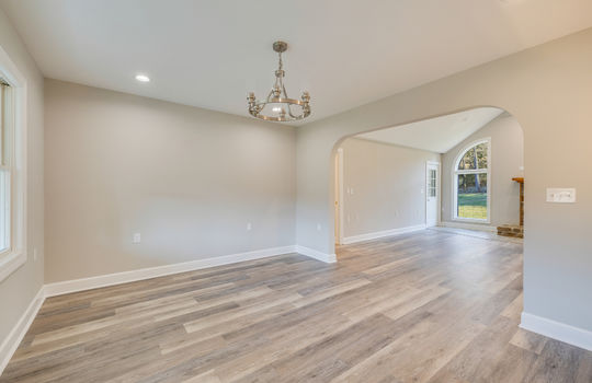 dining area, arched doorway, luxury vinyl plank flooring, chandelier, recessed lighting, view toward living room