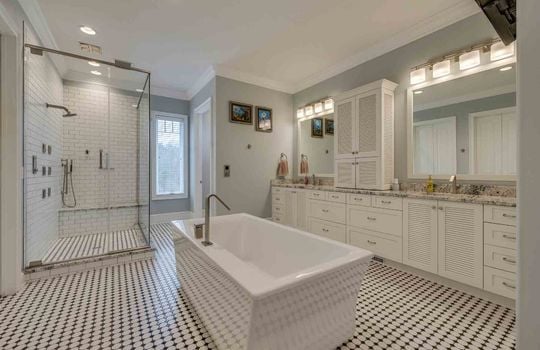 bathroom, soaker tub, tile shower with glass surround, large double sink vanity, tile flooring