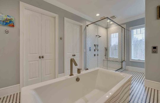 bathroom, soaker tub, tile flooring, tile shower with glass surround