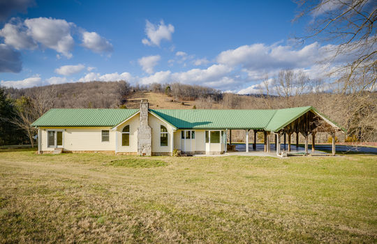back yard, metal roof, ranch style home, exterior doors, metal roof, covered carport, mountain views