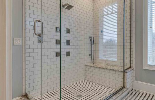 bathroom, tile shower, glass shower surround, tile flooring