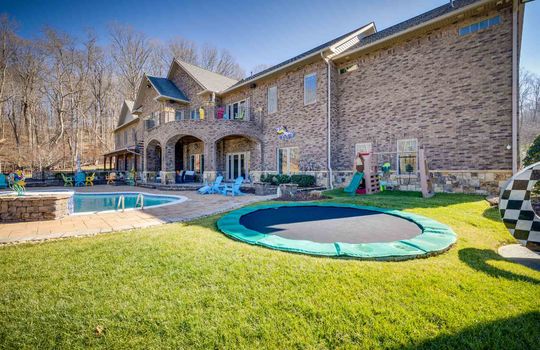 back yard, back of home, in ground swimming pool, patio, deck, outdoor kitchen