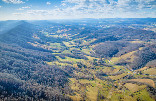 aerial view of property, mountain views, valley