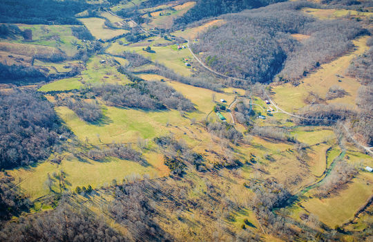 aerial view of property, mountain views, pastures, trees